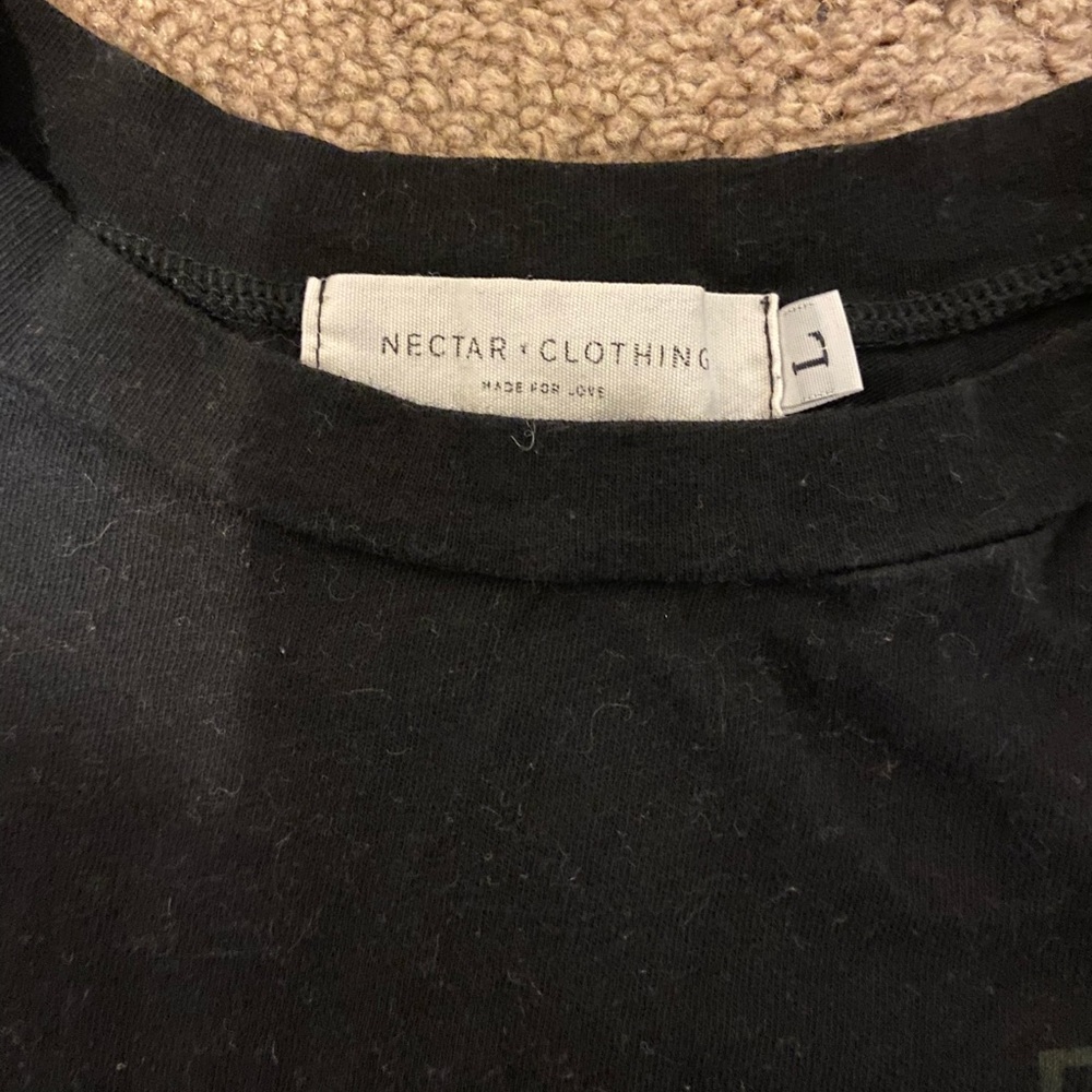 Black short (not cropped) T shirt. Says travel, super comfortable.
